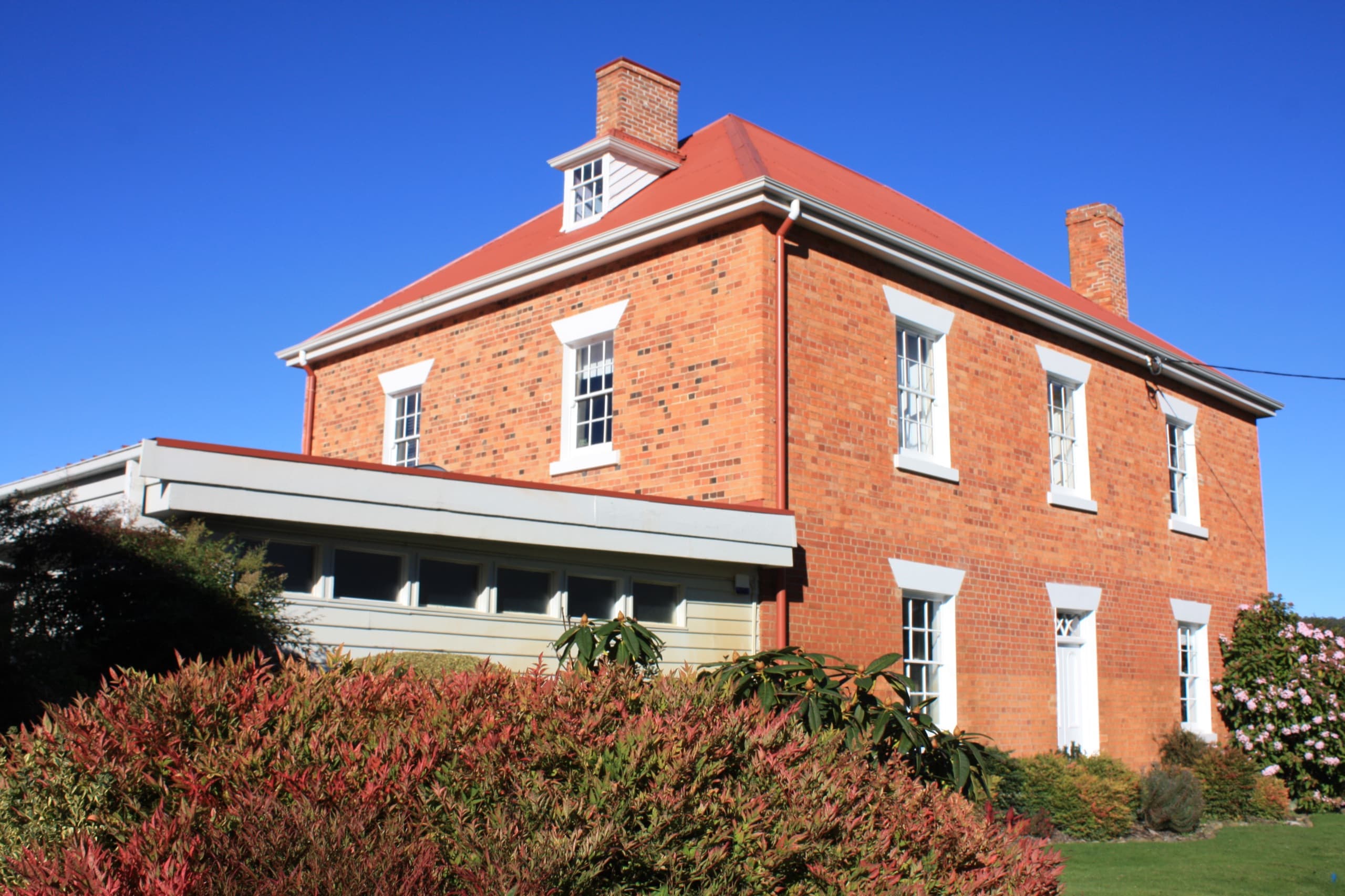 Heritage brickwork of the clubhouse under a clear winter sky